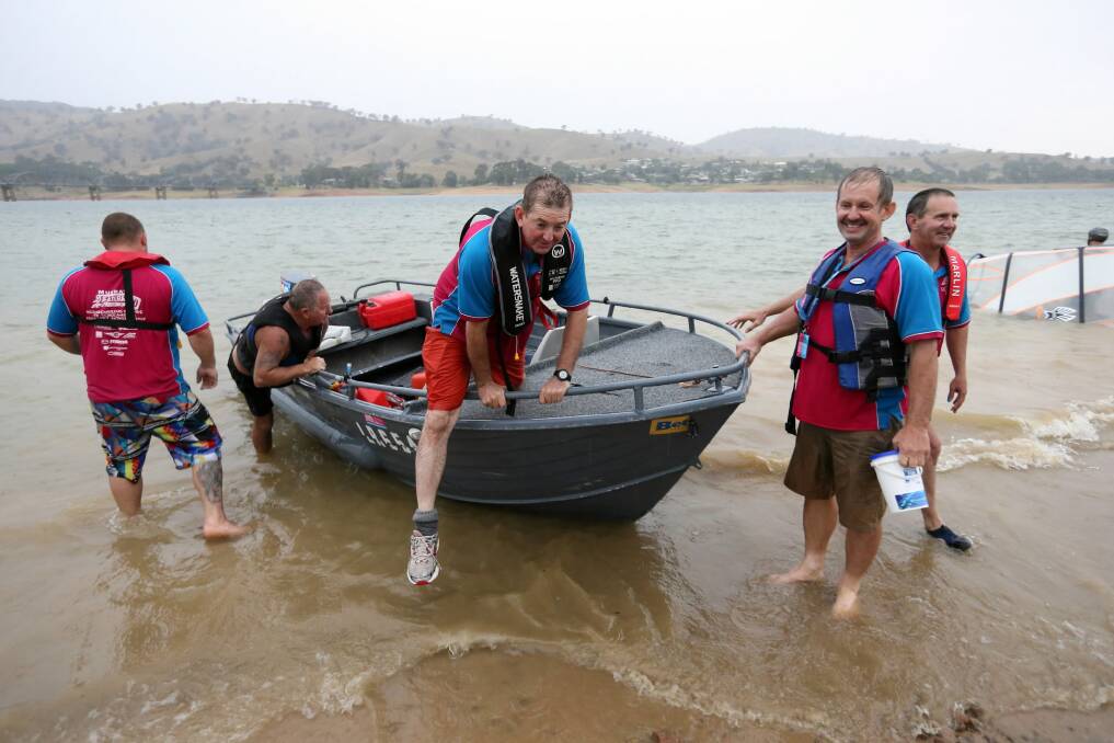 Murray Charity Meander participants caught a lift in this boat after their own boat became caught in rough conditions on Lake Hume. Pictures: PETER MERKESTEYN