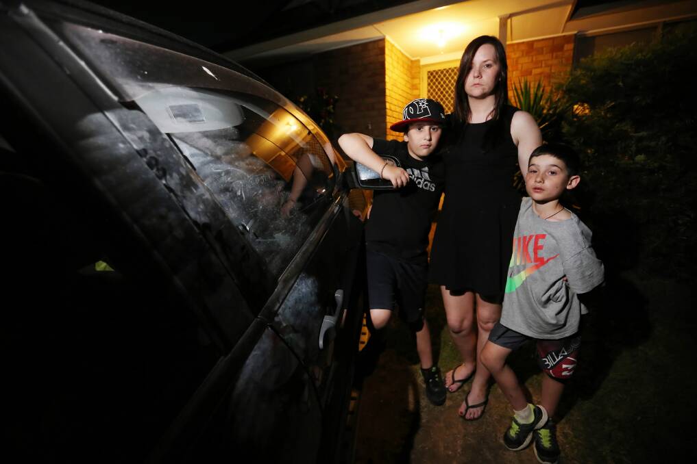 Melanie Nuggen with her children Jy, 9, and Jayden Mizzi, 10, and the car that was broken into, with a laptop which contained all of their family and baby photographs. Picture: JOHN RUSSELL