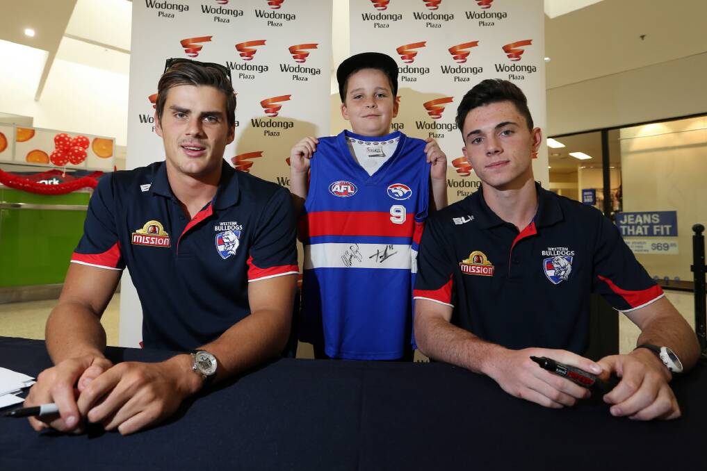 Bulldogs Tom Boyd and Toby Maclean autographed a guernsey for Jack Marengo, 10, of Wodonga at Wodonga Plaza yesyterday. Picture: MATTHEW SMITHWICK