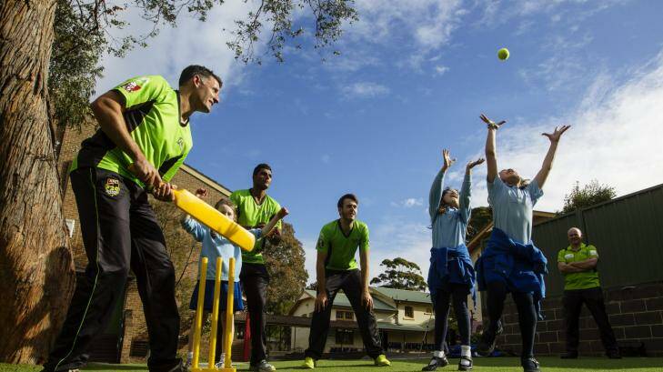 Willow key: Mike Hussey and his Sydney Thunder teammates at Annandale Public School on Wednesday. Photo: Nic Walker