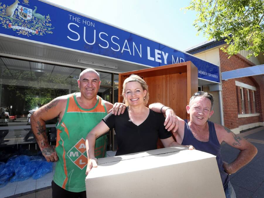 Sussan Ley moves into her new office with help from movers Anthony Johnstone and Maurie Harnett.