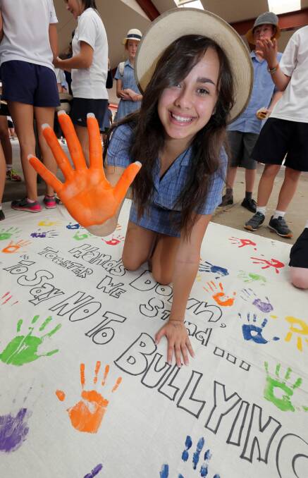 Student Elina Nassif, 16, uses her handprint as a pledge against bullying. Picture: PETER MERKESTEYN
