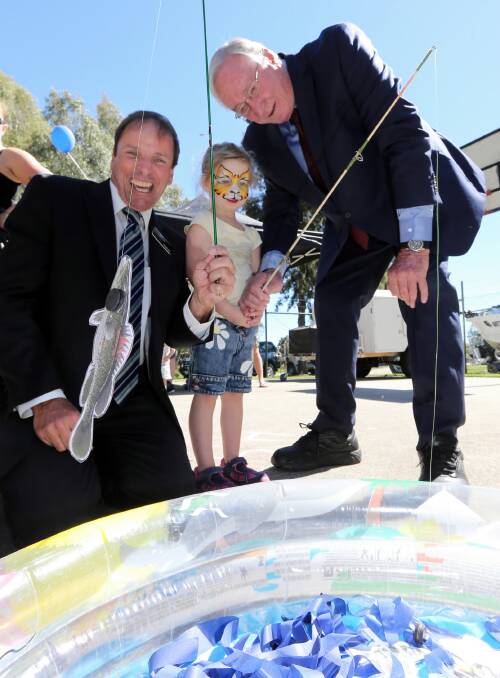 Ava Beall, 4, shows Rodney Wangman and Lou Lieberman, who originally opened the centre 21 years ago, how to fish at the anniversary party at Felltimber Community Centre. Picture: PETER MERKESTEYN