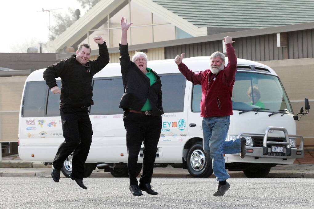 Scott Fraser, David Martin and Peter Russell celebrate receiving the new bus. Picture: KYLIE ESLER