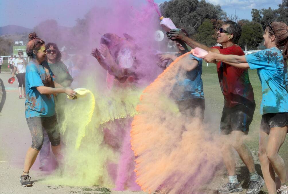 All the colours of the rainbow ... Mitch Brown gets a splash of colour from Lucy Hunter, Anjil Henry, Greg Sheridan and Anabelle Sheridan, all from Albury, at yesterday’s Rainbow Run. Pictures: PETER MERKESTEYN