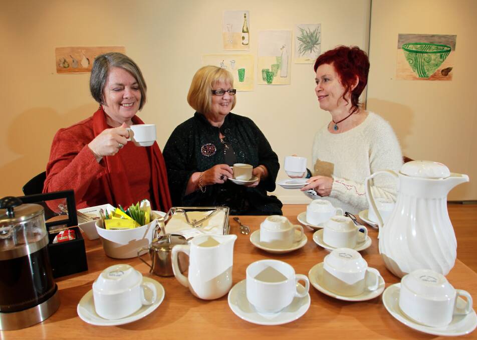 Border artists Paula Watson, Susan Morris and Caryn Giblin discuss their artworks on display at Arts Space Wodonga over a cuppa for their exhibition called At The Table. Picture: KYLIE ESLER