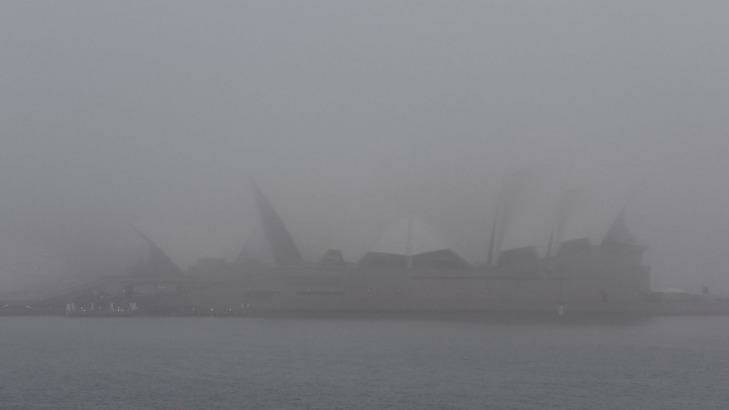 A thick fog shrouds the Sydney Opera House on Monday morning.  Photo: Peter Rae