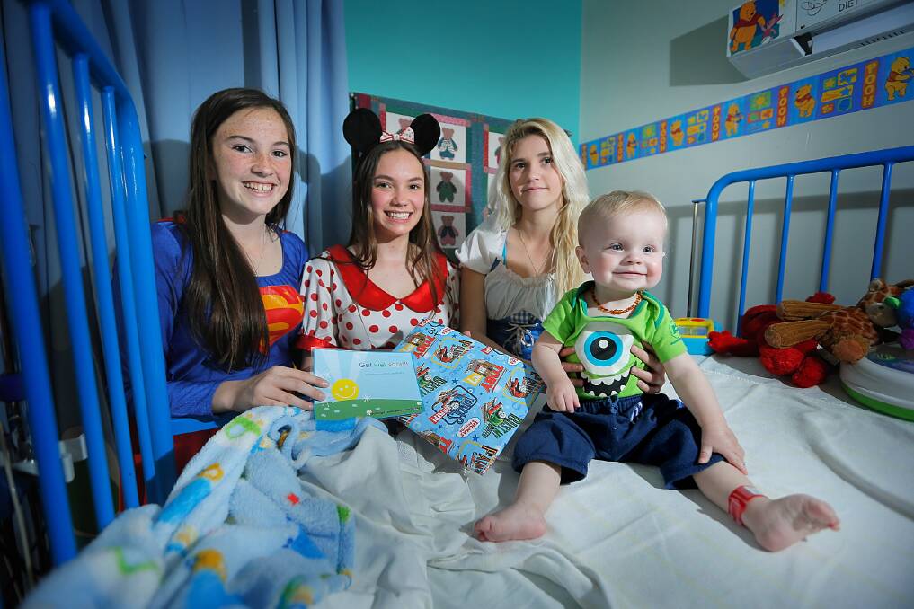 Rebecca Pilfoot, Ruby Delacy, and Kirsty Hearne baked cupcakes to raise money for children at Albury hospital, including Leo Lieschke, 14 months, of Lavington. Picture: TARA GOONAN