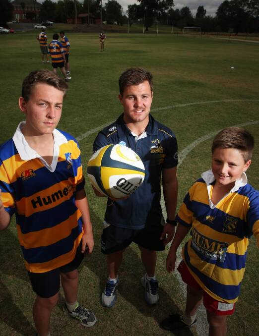 Brumbies development officer Jack Burey and The Scots School year 9 students and rugby players Josh Bookallil (left) and Louis Simpson prepare for the tournament. Picture: DYLAN ROBINSON