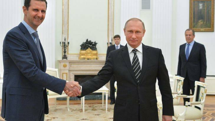 Putin shakes hand with Syrian President Bashar Assad in October 2015. Photo: Alexei Druzhinin