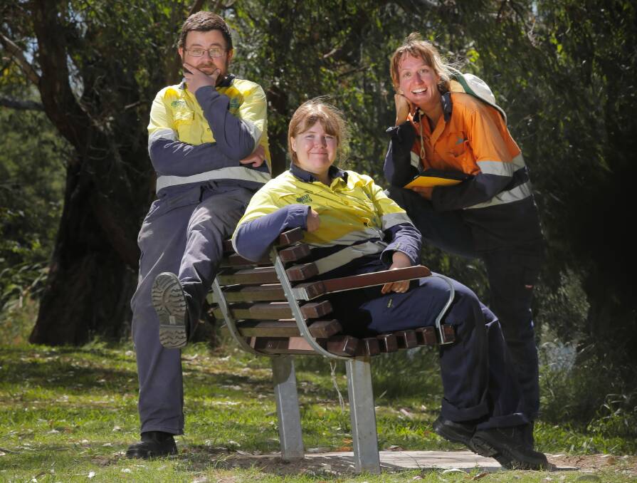 Green Army graduates Kyle Fredricksen and Bethany Gillard with their supervisor Maria Bertoncini lounging on a chair they installed. Picture: KYLIE ESLER