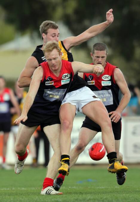 Milawa’s Steven Williamson and Glenrowan’s Lachlan Cohen tangle in last year’s grand final. The Kelly Tigers and the Demons will lock horns again this week with the minor premiership likely to be on the line.