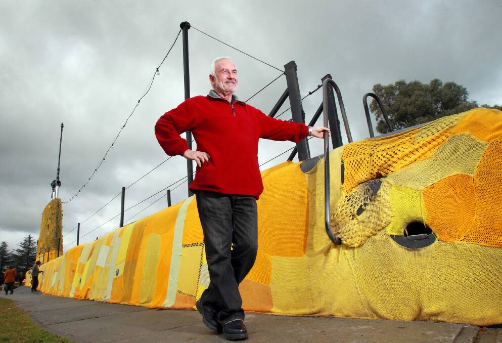 Holbrook’s Michael Carew inspects the yarn-bombed submarine before the wool is taken down today. Picture: KYLIE ESLER