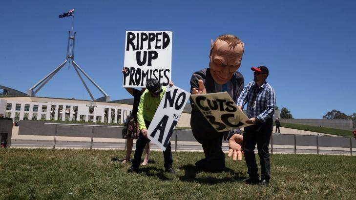 Protesters rally against the planned cuts to the ABC in front of Parliament House. Photo: Andrew Meares