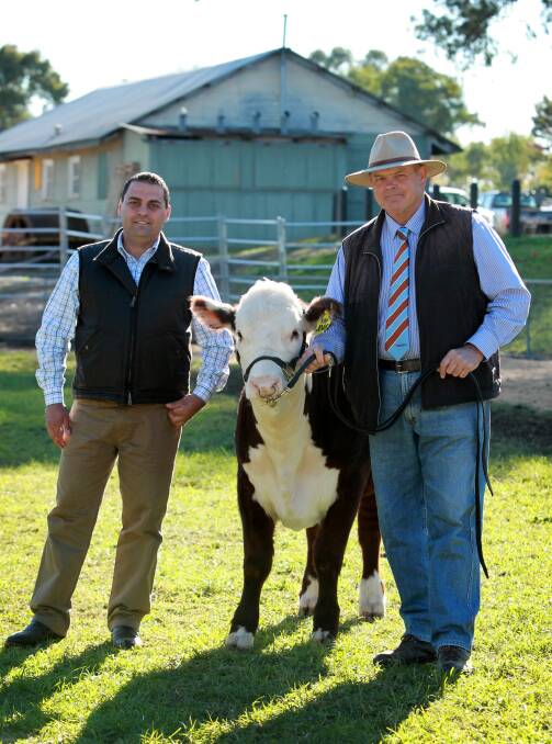 Alvio Trovatello accepts the heifer from Paul Rogers after it fetched $5000 that will be donated to a rescue service. Picture: MATTHEW SMITHWICK