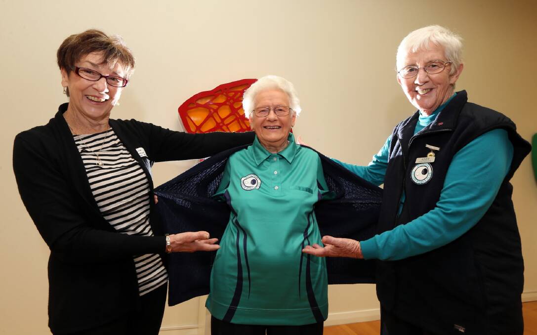 Wodonga’s indoor bowls club vice president Linda McWaters shows off the new standard teal uniform for club president Norma Walsh and secretary Jenny Scattergood. Picture: PETER MERKESTEYN