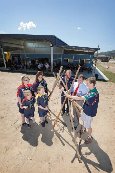 Scout Tom Heaven shows Wodonga mayor Rod Wangman how to build a shelter behind the new building while group leader Greg Spam watches on with Rover Amanda Harrison, Venturer Georgia Nieuwirth, Joey Charlotte Walters and Cub Kylarnee Walters. Picture: TARA GOONAN