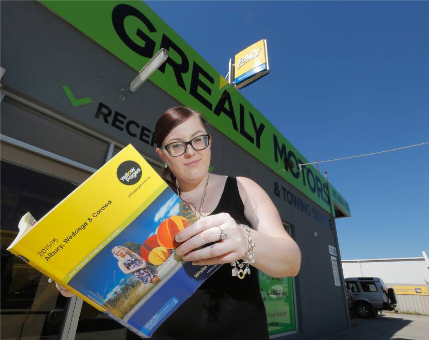 Grealy Motors administration manager Laura Grealy with the new phone book that has a listing for a business using their name. Picture: KYLIE ESLER