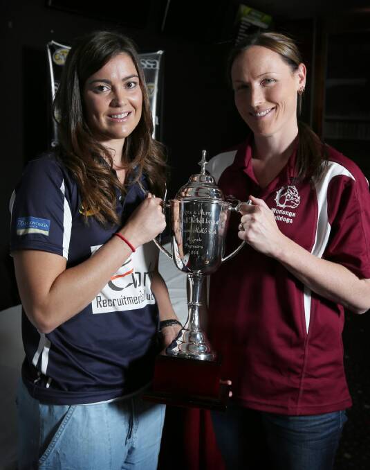 Yarrawonga’s Annalise Grinter and Wodonga’s Rebecca Cameron got their hands on the premiership cup yesterday, but only one will get a second look at the silverware on Sunday. Picture: MATTHEW SMITHWICK