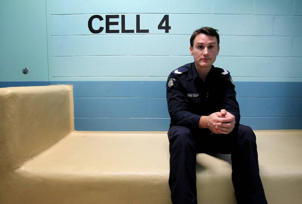 Sen-Constable James Donovan at the Wodonga police station cells where young drivers could find themselves after drinking or texting behind the wheel. Picture: Kylie Esler