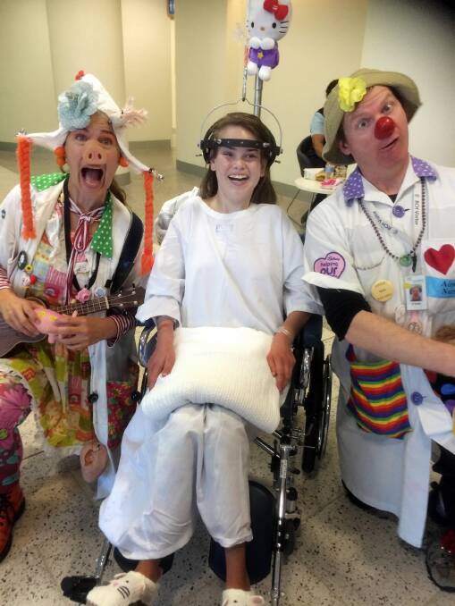 Paige McDonald with clowns at the Royal Children’s Hospital yesterday. Picture: FAIRFAX