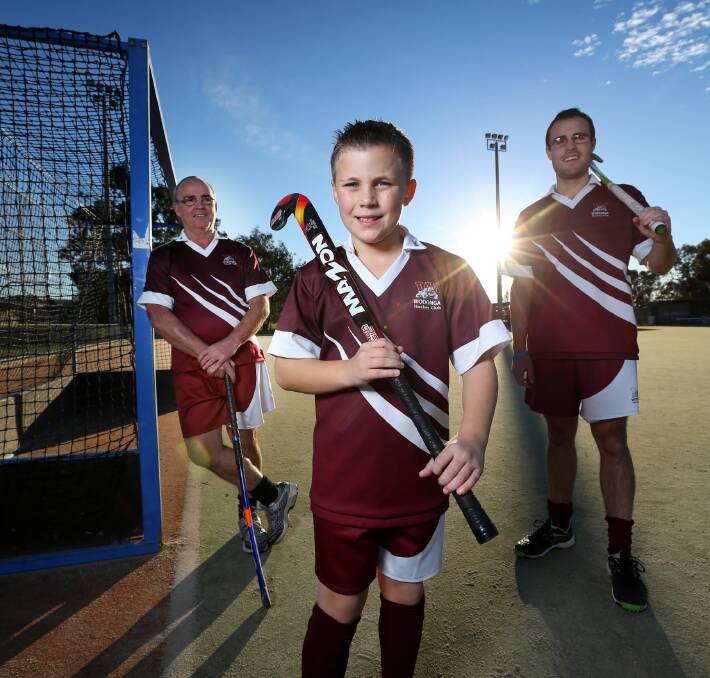 Phil McQuilton, his grandson Brayden Mulrooney, 10, and son Kieran McQuilton, represent three generations of a family which has been part of the Wodonga Hockey Club since its inception in 1972. The club will celebrate its 40th birthday next weekend. Picture: MATTHEW SMITHWICK