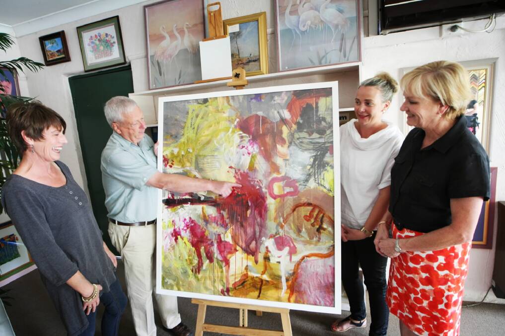 Country Framing’s Bill Foot and Gold Cup Charity Limited’s Mary Judd (left), Cate Miller and Stephanie Strong admire Jo Davenport’s painting Song Of Joy, which will be an auction prize. Picture: DYLAN ROBINSON