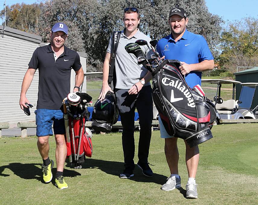 Daniel Maher, Andrew Dess and Brendan Fevola enjoy a hit of golf yesterday. Picture: PETER MERKESTEYN
