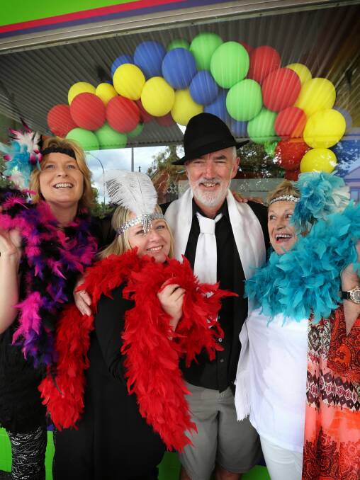 Karyn Herzina, Tania Scott, David Dow and Di Mant try on cabaret costumes at Spiders Party Shop in Albury ahead of the fundraising evening for Carevan. Picture: MATTHEW SMITHWICK