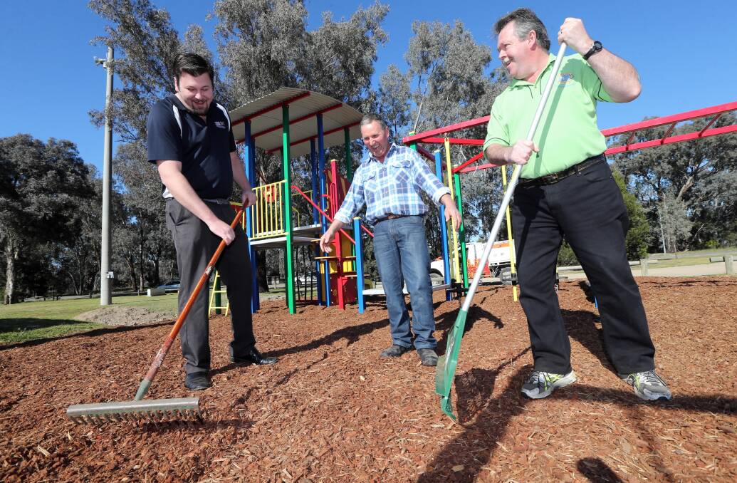 Albury councillor Ross Jackson, Thurgoona Football Netball Club facilities manager Bill Smith and Thurgoona Lions Club first vice-president Ian Crane finish off the upgrades. Picture: PETER MERKESTEYN