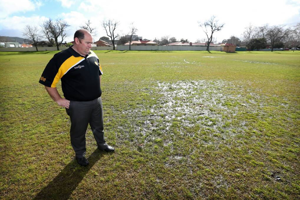 Hotspurs coach John Irvine inspects a waterlogged Aloysius Park this week. Picture: MATTHEW SMITHWICK