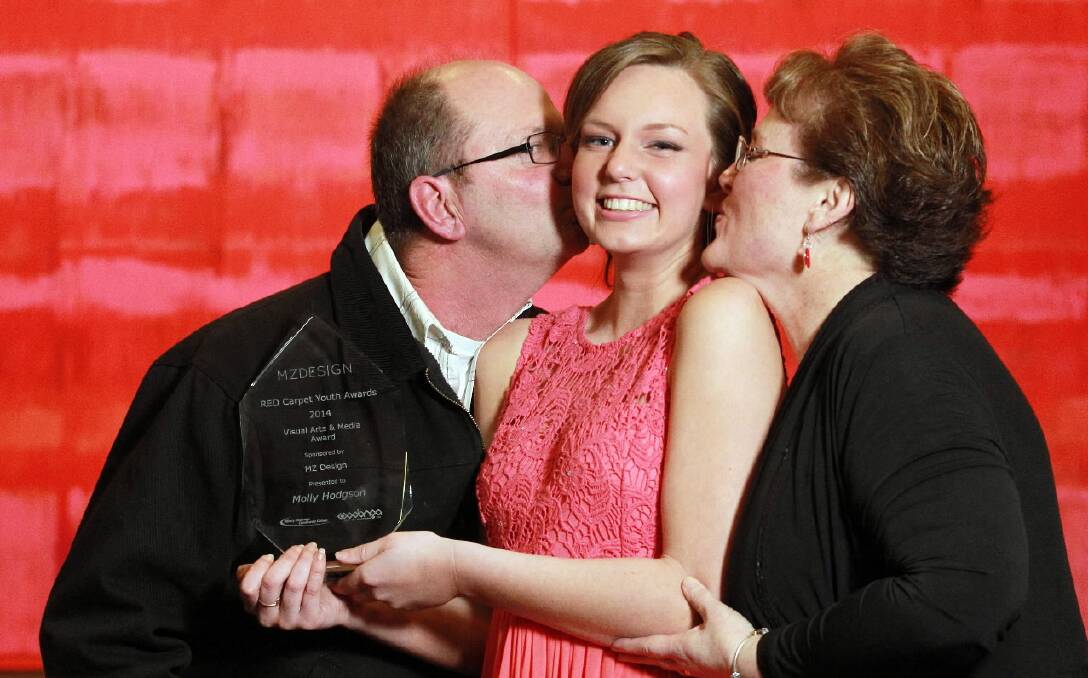 Molly Hodgson, 16, receives a kiss from her parents Brian and Leanne Hodgson after winning the Visual Arts and Media Award. Pictures: KYLIE ESLER