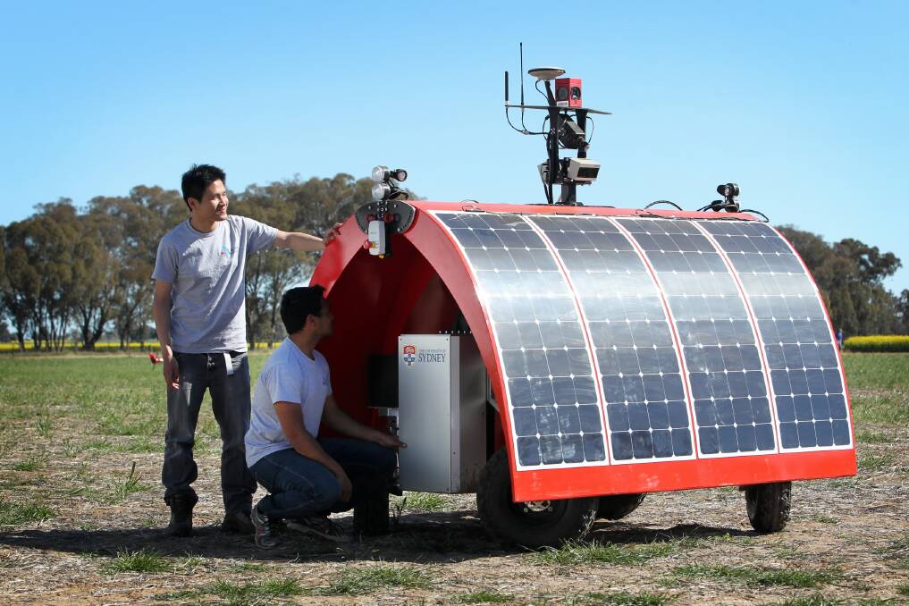 Dr Calvin Hung, research fellow in robotics, and Suchet Bargoti, PHD student in robotics, and the Ladybird, a mobile ground robot being demonstrated at Henty. Picture: MATTHEW SMITHWICK