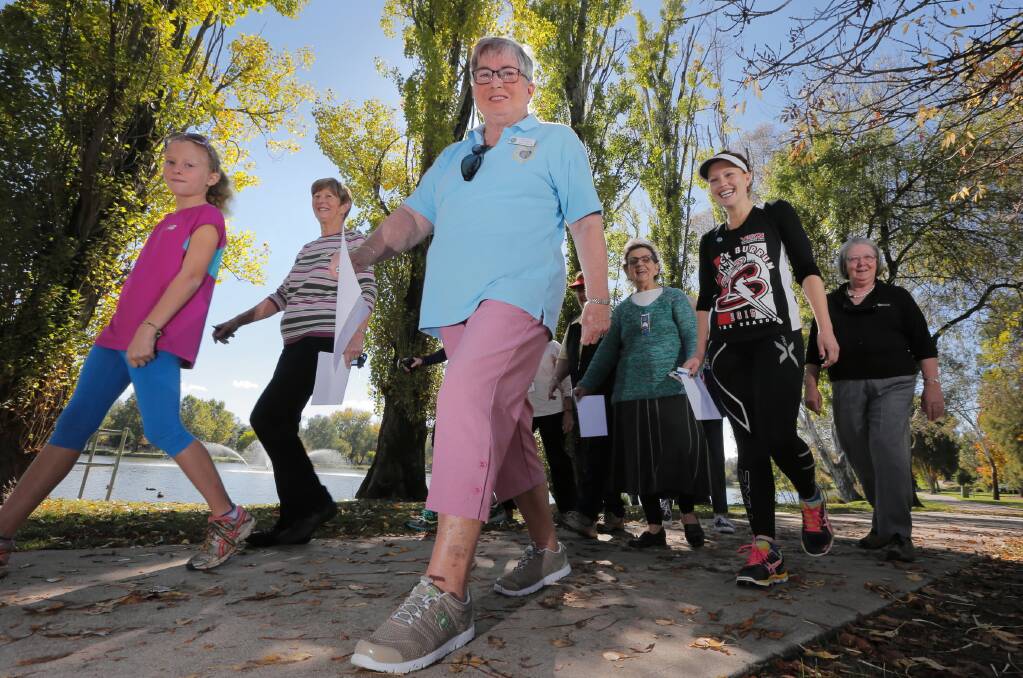 Lynette Buck, group International organiser with Murray Group CWA, leads some of the participants of yesterday’s walk around the Sumsion gardens. Picture: KYLIE ESLER