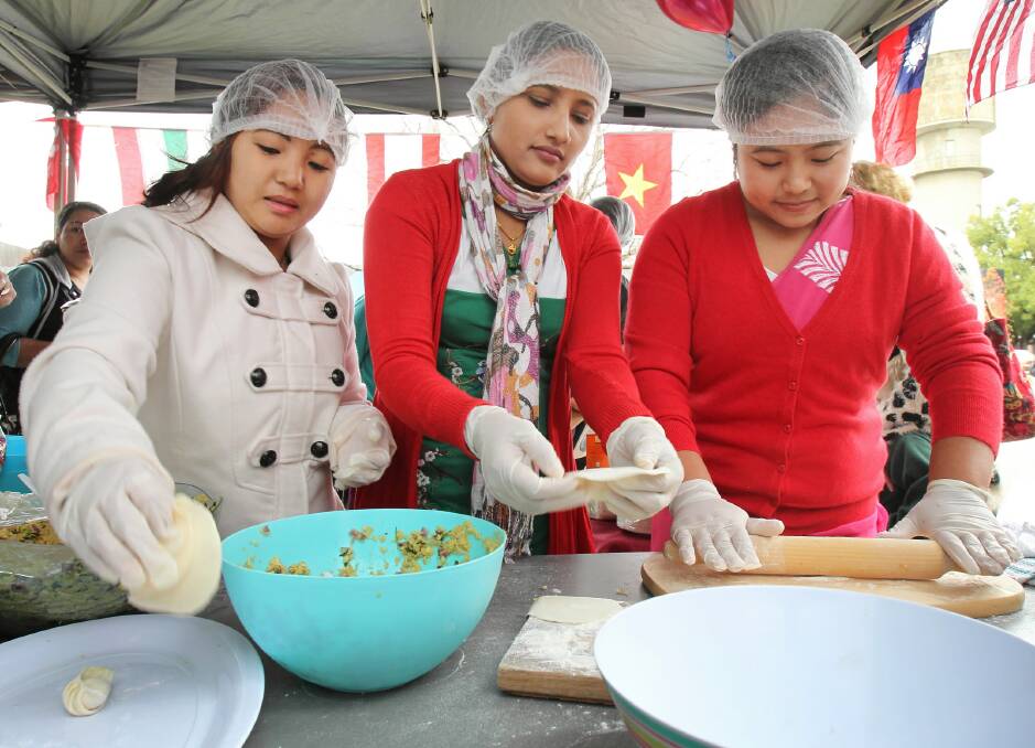 Bhutanese refugees Biula Rai, Devi Khanal and Ambika Monger, all from Wodonga, were busy making dumplings. Pictures: KYLIE ESLER