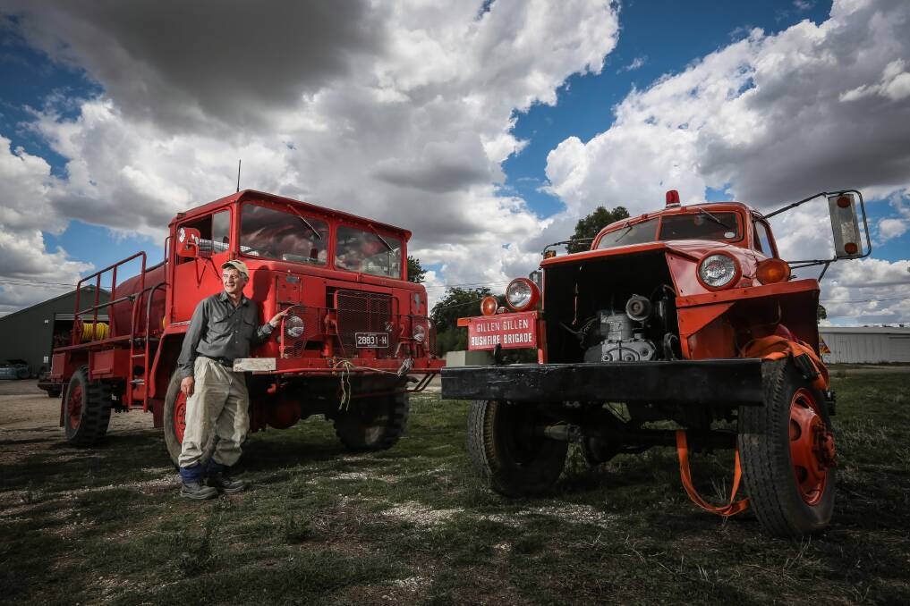 Colin Young with his fire trucks, a 1968 International Mark IV and a 1943 Studebaker, which will be on show at the military vehicles weekend next month. Picture: DYLAN ROBINSON