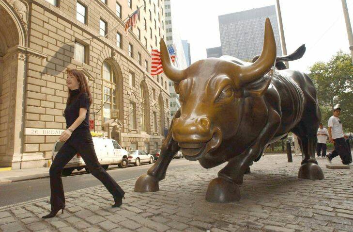 The Wall Street bull looks as if it is charging a young passerby at Bowling Green in New York Monday September 24, 2001. The Dow Jones Industrial Average rose 367.49, or 4.5 percent, to 8603.30. Before today, it had fallen eight days running, including three sessions prior to the attack. Photographer: Jennifer S. Altman/Bloomberg News. merrill bull