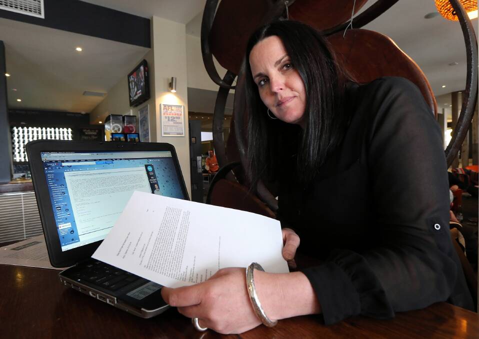 Jodie Tiernan with the email that was sent with her old e-signature and name saying she was robbed. Picture PETER MERKESTEYN