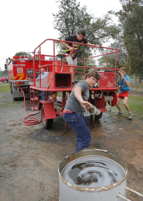 Kynan Beacon, 21, Jarrod Cleveland, 17, and Tyson Brown, 16, touch up their skills, above, and below, Nathan Cofield, 15, runs out the hose during a training drill. Pictures: TARA GOONAN