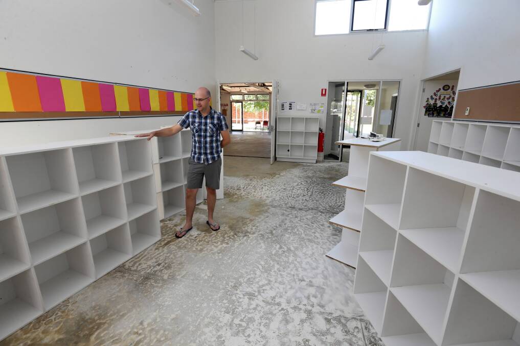 Cain McDonald inspects damage to a building with four classrooms at Victory Lutheran College. Picture: PETER MERKESTEYN
