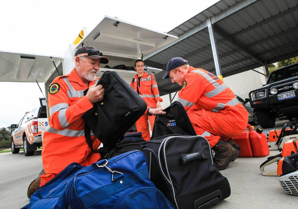 John Stava, Amanda Cohn and Geoff Hudson at the Albury SES headquarters yesterday after returning from Sydney.
Pictures: DYLAN ROBINSON