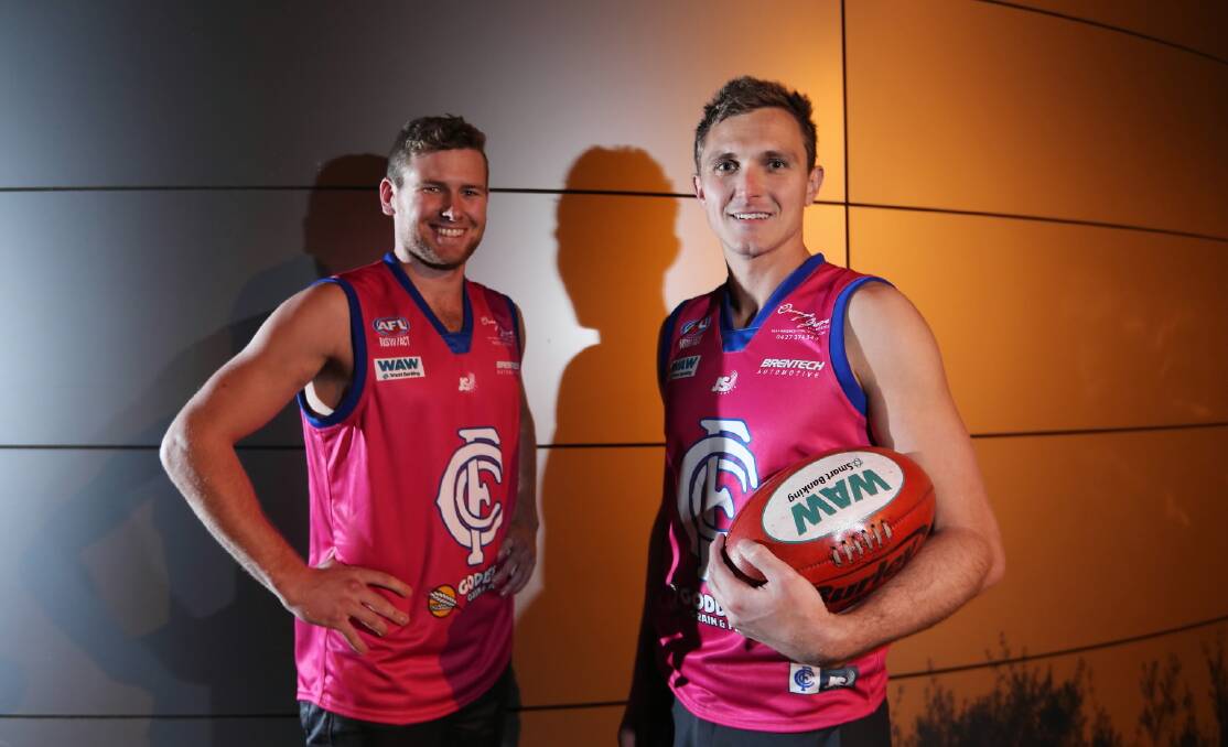 Culcairn players Jackson McGrath and Adam Eady model the pink guernseys they will wear against the Saints on Saturday. The guernseys will be auctioned after the game, with proceeds going to the Breast Cancer Network. Picture: MATTHEW SMITHWICK