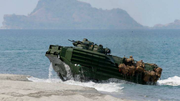 A US Navy amphibious assault vehicle with Philippine and US troops on board storms the beach at a combined assault exercise opposite one of the disputed South China Sea islets. Photo: Bullit Marquez
