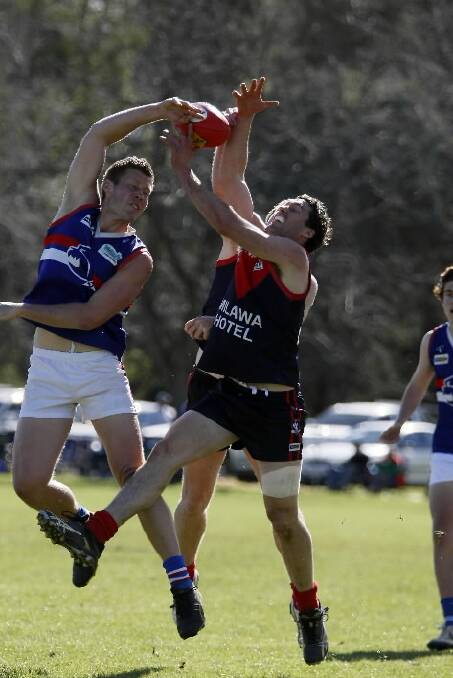 Hamish Moore and John Conroy compete for the ball.