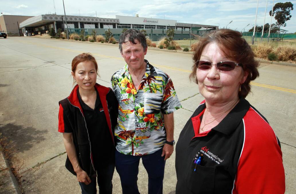 Employees Thongsy Sourivong, Terry Meredith and Irene Wojtkowski share memories of their years working at the Lavington plant on their final day yesterday. Picture: KYLIE ESLER