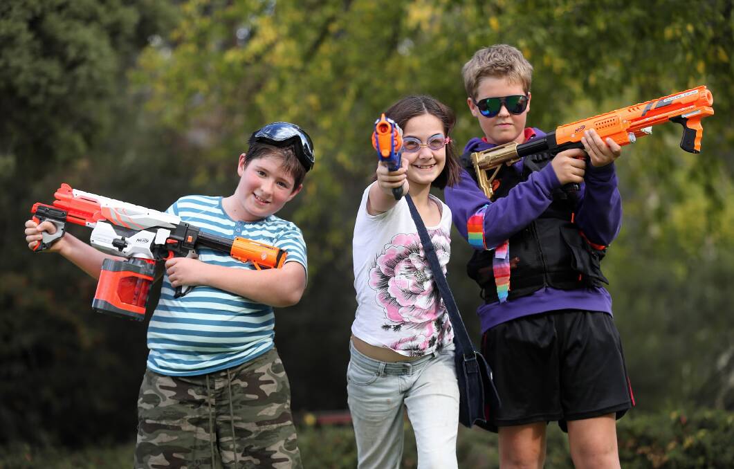 War, what is it good for? Holiday fun, say Elijah Davison, Melissa Halford, and Jack Anderson, participants in yesterday’s Humans v Zombies battle for Hovell Tree Park. Picture: JOHN RUSSELL