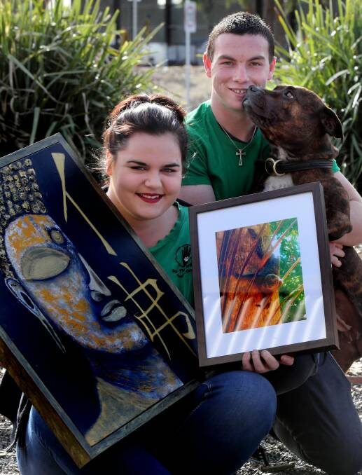 Founder of For the Animals youth group Nicola Jones, and volunteer Kyle Yates are holding an art auction to help animals like Pony the staffy. Picture: PETER MERKESTEYN