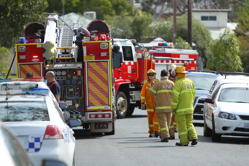 Firefighters at the scene of the house fire that broke out in Spring Avenue, Wodonga, yesterday afternoon.