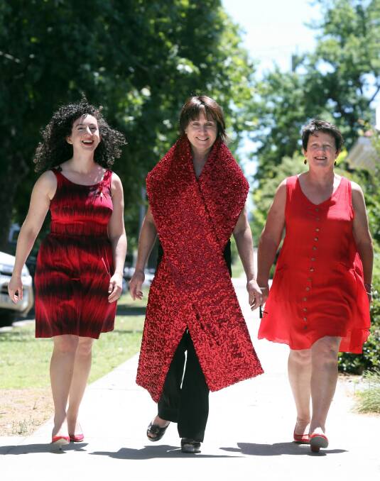 LADIES IN RED: Orly Janover, Bridget Doyle and Alison Kincaid. Picture: PETER MERKESTEYN