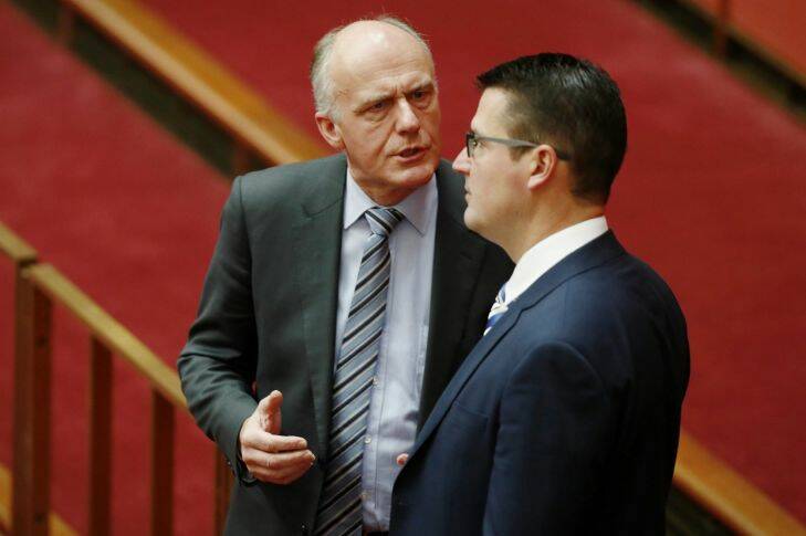 Senators Eric Abetz and Zed Seselja in  discussion in the Senate at Parliament House in Canberra on Monday 11 September 2017. Fedpol Photo: Alex Ellinghausen